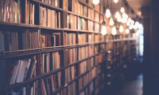 A library lit by hanging lights